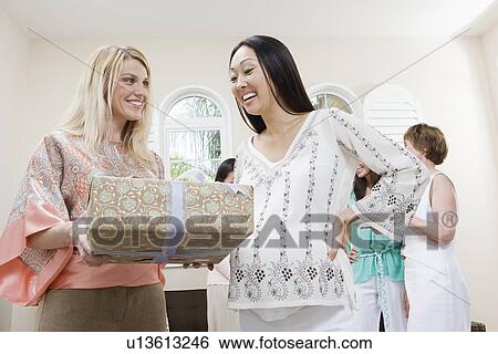 Stock Photograph - Pregnant Asian Woman with friend at a Baby Shower. Fotosearch