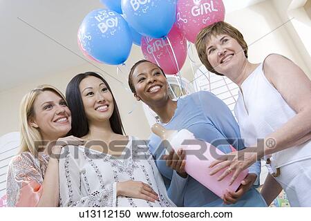 Stock Image - Pregnant Asian Woman with Friends at a Baby Shower, Low Angle. Fotosearch