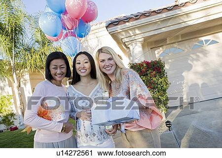 Stock Image - Pregnant Asian Woman with Mother and Friend at a Baby Shower. Fotosearch