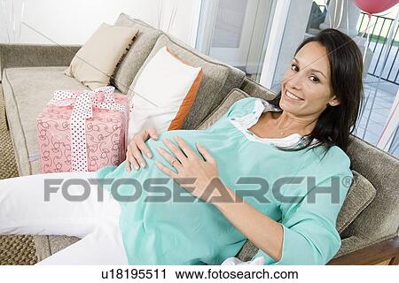 Pregnant Woman resting on Couch at Baby Shower View Large Photo Image Stock Image - Pregnant Woman resting on Couch at Baby Shower. Fotosearch