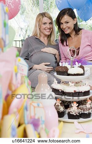 Picture - Pregnant Woman with Friend at a Baby Shower. Fotosearch