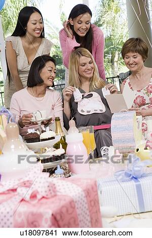 Stock Image - Pregnant Woman with friends at a Baby Shower. Fotosearch