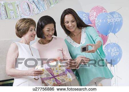 Pregnant Woman with Friends at a Baby Shower, Taking Photos View Large Photo Image Stock Photograph - Pregnant Woman with Friends at a Baby Shower, Taking Photos. Fotosearch