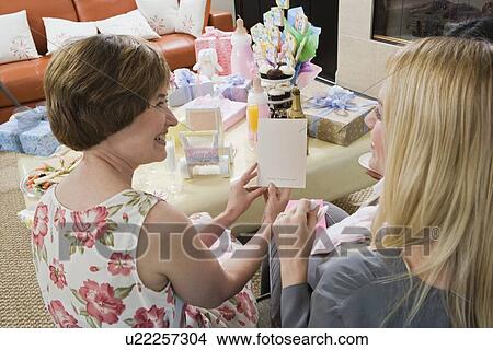 Picture - Pregnant Woman with Mother at a Baby Shower. Fotosearch