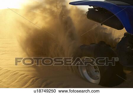 Quad bike spraying up sand in desert, close up View Large Photo Image Stock Image - Quad bike spraying up sand in desert, close up. Fotosearch