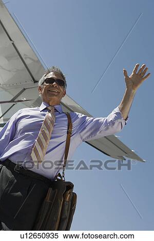 Senior businessman outside of private jet. View Large Photo Image Stock Photography - Senior businessman outside of private jet.. Fotosearch