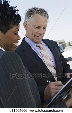 Senior businessman signing documents. View Large Photo Image Stock Photograph - Senior businessman signing documents.. Fotosearch
