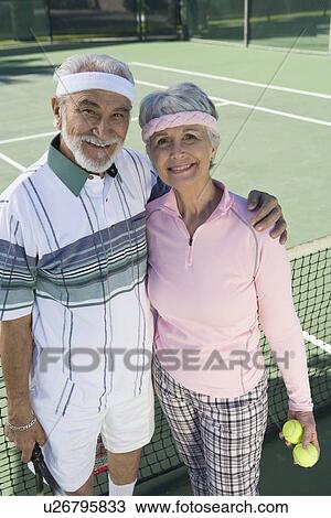 Senior couple at tennis court, portrait View Large Photo Image Stock Image - Senior couple at tennis court, portrait. Fotosearch