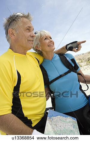 Senior couple reading maps View Large Photo Image Picture - Senior couple reading maps. Fotosearch