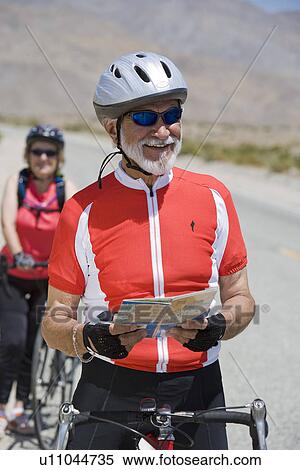 Senior couple riding bikes View Large Photo Image Stock Photography - Senior couple riding bikes. Fotosearch