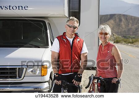 Senior couple with bikes on road View Large Photo Image Stock Photo - Senior couple with bikes on road. Fotosearch