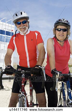 Stock Photograph - Senior couple with bikes. Fotosearch