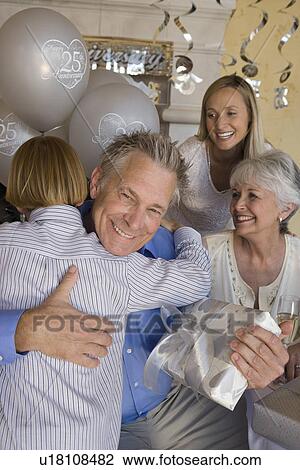Senior man celebrating birthday with family View Large Photo Image Stock Image - Senior man celebrating birthday with family. Fotosearch