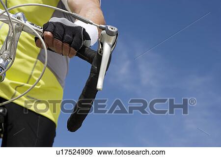 Senior man cycling, close-up of handlebar View Large Photo Image Stock Photo - Senior man cycling, close-up of handlebar. Fotosearch