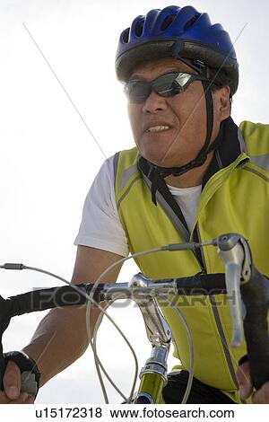 Stock Photo - Senior man cycling. Fotosearch