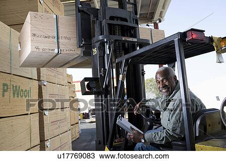 Senior man driving forklift truck View Large Photo Image Stock Image - Senior man driving forklift truck. Fotosearch