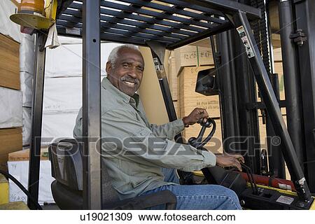 Senior man driving forklift truck View Large Photo Image Stock Photo - Senior man driving forklift truck. Fotosearch