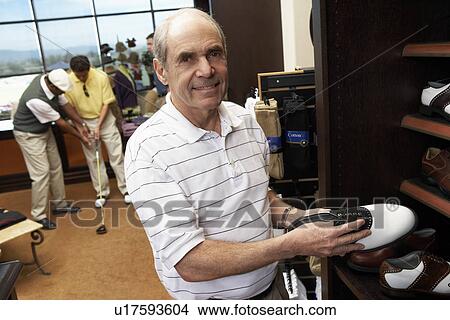 Senior Man in Golf Shop shopping for golf shoes View Large Photo Image Picture - Senior Man in Golf Shop shopping for golf shoes. Fotosearch