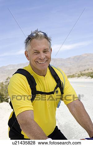Stock Photo - Senior man on bike. Fotosearch