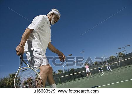 Senior man playing tennis View Large Photo Image Stock Photo - Senior man playing tennis. Fotosearch