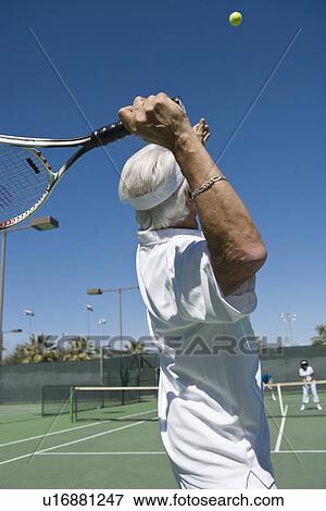 Stock Photo - Senior man playing tennis. Fotosearch