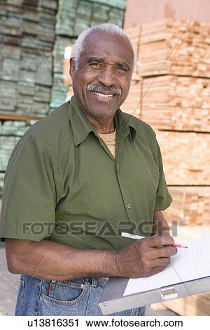 Senior man stock-taking in warehouse View Large Photo Image Stock Image - Senior man stock-taking in warehouse. Fotosearch