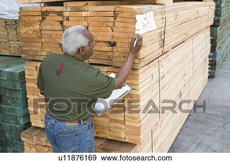 Stock Photo - Senior man stock-taking in warehouse. Fotosearch
