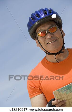 Senior man wearing cycling helmet View Large Photo Image Stock Photo - Senior man wearing cycling helmet. Fotosearch