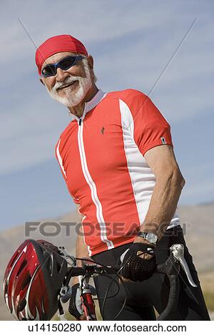 Stock Image - Senior man with bike. Fotosearch