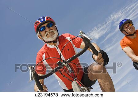 Stock Photo - Senior men cycling. Fotosearch