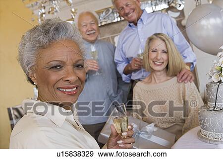 Stock Photo - Senior people celebrating birthday. Fotosearch