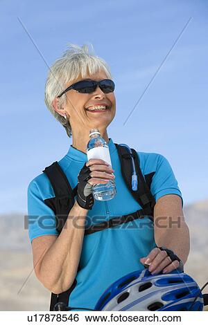 Stock Photograph - Senior woman drinking water. Fotosearch