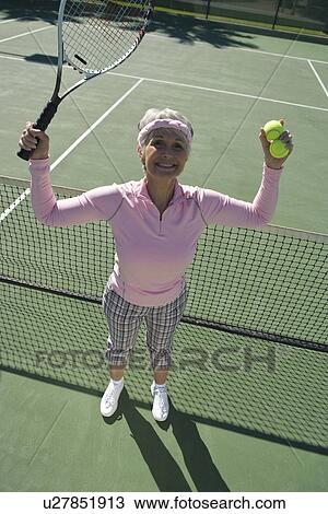Senior woman on tennis court, portrait View Large Photo Image Stock Image - Senior woman on tennis court, portrait. Fotosearch