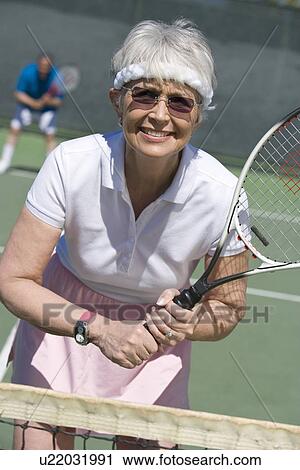Senior woman playing tennis, portrait View Large Photo Image Stock Image - Senior woman playing tennis, portrait. Fotosearch
