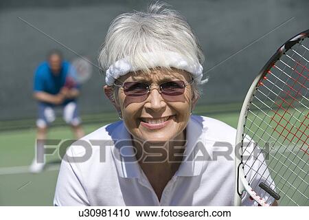 Senior woman playing tennis, portrait View Large Photo Image Stock Image - Senior woman playing tennis, portrait. Fotosearch