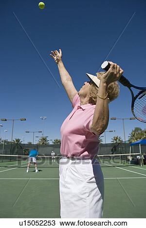 Senior woman playing tennis View Large Photo Image Stock Image - Senior woman playing tennis. Fotosearch