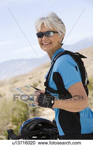 Senior woman reading map View Large Photo Image Stock Image - Senior woman reading map. Fotosearch