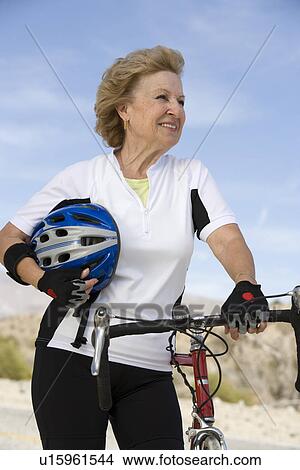 Picture - Senior woman with bike. Fotosearch