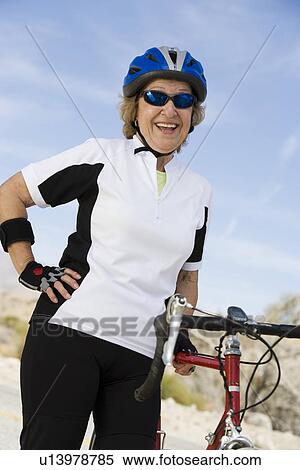 Stock Photography - Senior woman with bike. Fotosearch