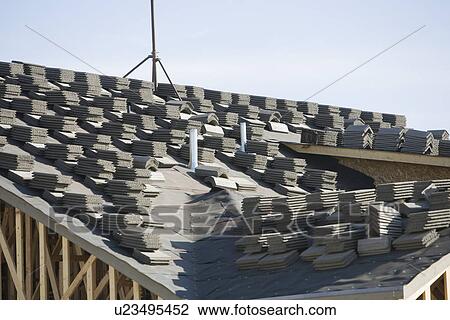 Stacks of tiles on house roof View Large Photo Image Stock Image - Stacks of tiles on house roof. Fotosearch