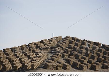 Picture - Stacks of tiles on roof. Fotosearch