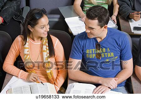 Student couple sitting in lecture hall View Large Photo Image Stock Image - Student couple sitting in lecture hall. Fotosearch