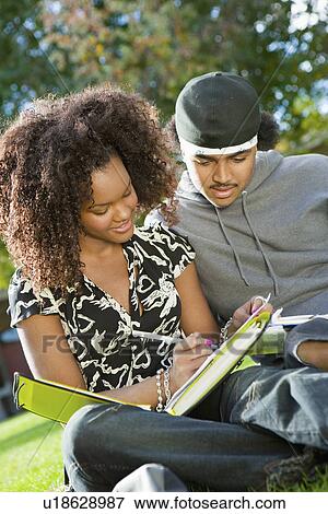 Stock Photo - Student couple studying outdoors. Fotosearch