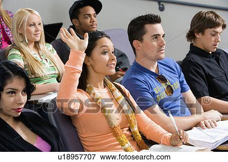 Stock Photo - Student raising hand during class lecture. Fotosearch