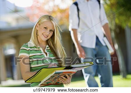 Student writing in notebook, outdoors, (portrait) View Large Photo Image Stock Photo - Student writing in notebook, outdoors, (portrait). Fotosearch