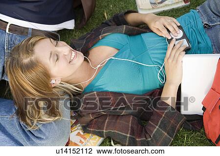 Students relaxing on grass View Large Photo Image Stock Image - Students relaxing on grass. Fotosearch