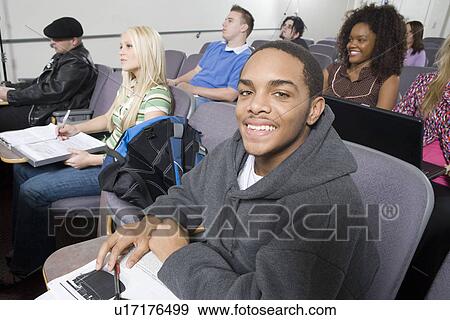 Stock Photo - Students sitting in lecture hall. Fotosearch