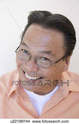 Studio portrait of man smiling View Large Photo Image Picture - Studio portrait of man smiling. Fotosearch