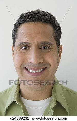 Stock Image - Studio portrait of man smiling. Fotosearch