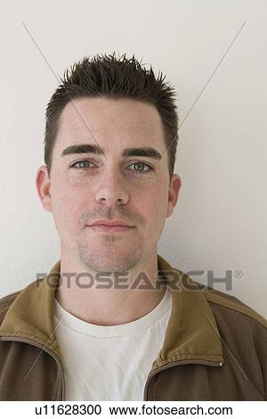Stock Image - Studio portrait of young man. Fotosearch